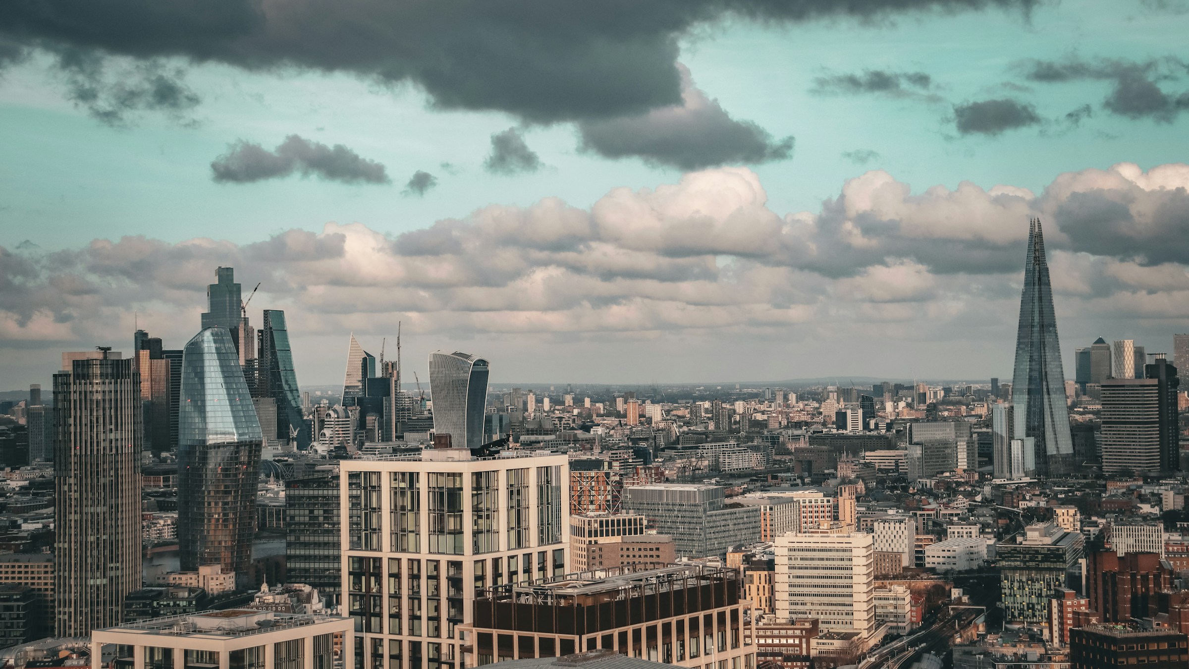 London's modern skyline beneath a cloud-filled sky